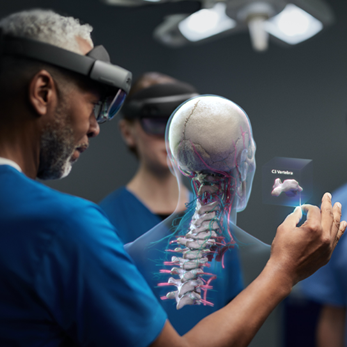 Healthcare worker earing Hololens 2 headset looking at hologram of the C3 vertebra